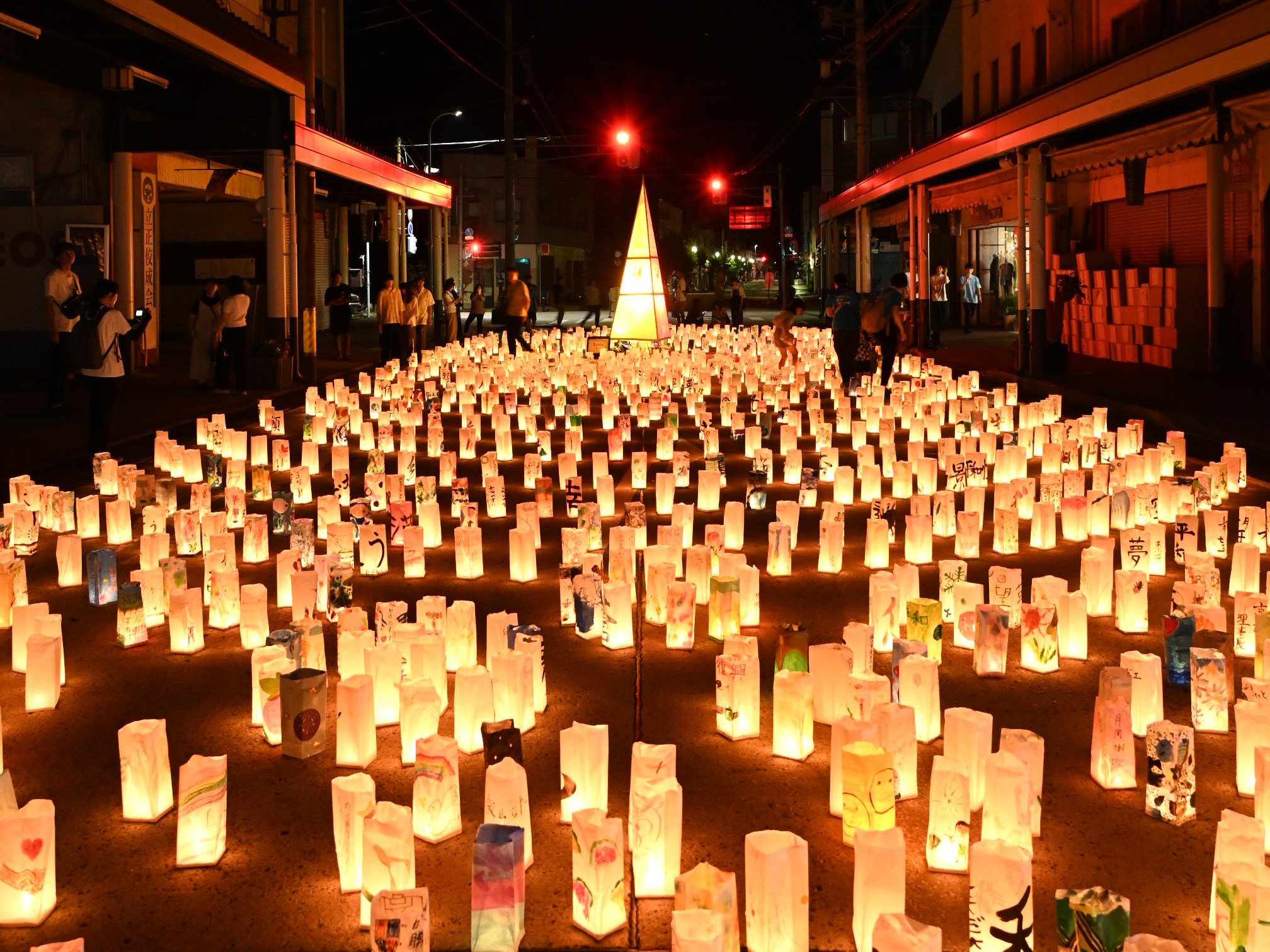 Rows of hand-painted paper lanterns glowing at night along Honmachi shopping street in Iiyama